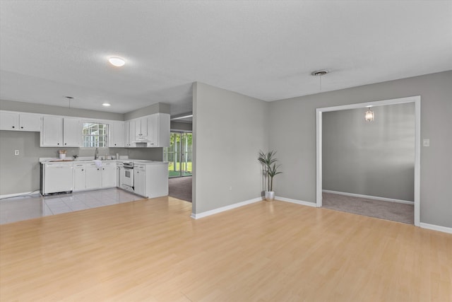 2701 Gardenbrook Ct, Augusta, GA 30906 - unfurnished living room featuring light wood finished floors, baseboards, a sink, and a textured ceiling