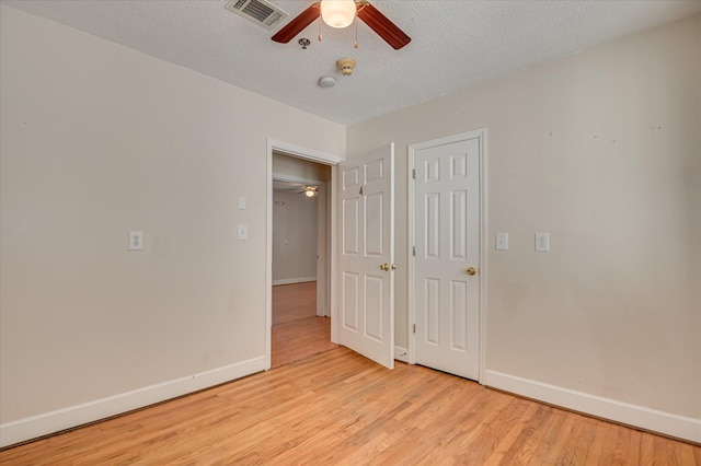 280 W Forrest St, Harlem, GA 30814 - unfurnished bedroom with baseboards, light wood-style floors, a textured ceiling, and a ceiling fan