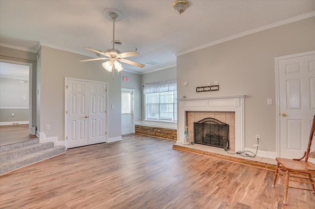 280 W Forrest St, Harlem, GA 30814 - unfurnished living room featuring wood finished floors, a ceiling fan, baseboards, crown molding, and a tiled fireplace