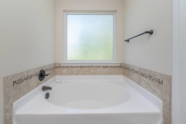 full bath with a garden tub and a healthy amount of sunlight