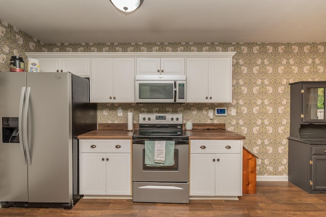 kitchen featuring white cabinets, dark wood-style flooring, stainless steel appliances, wallpapered walls, and baseboards