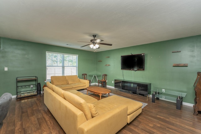 living area featuring baseboards, ceiling fan, and wood finished floors