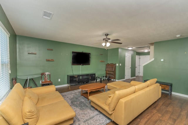 living area featuring baseboards, a ceiling fan, wood finished floors, and visible vents