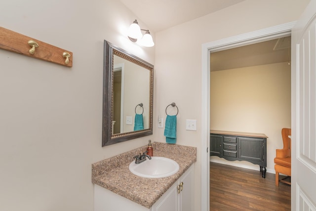 bathroom featuring vanity, baseboards, and wood finished floors