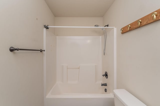 bathroom with toilet and  shower combination