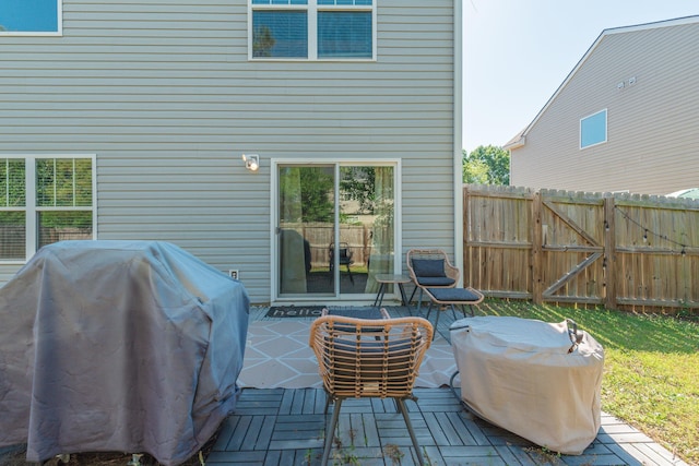 wooden deck with fence and area for grilling