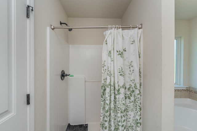 full bath featuring a bathing tub and a shower with shower curtain