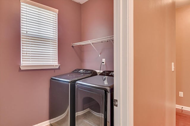 laundry area featuring laundry area, baseboards, and separate washer and dryer