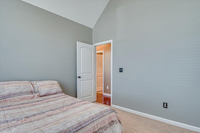 bedroom with baseboards, carpet floors, and high vaulted ceiling