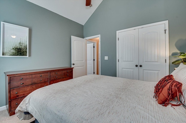 carpeted bedroom featuring a closet, ceiling fan, and lofted ceiling