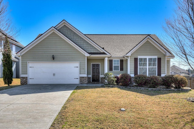 view of front of property with an attached garage, a shingled roof, driveway, and a front yard