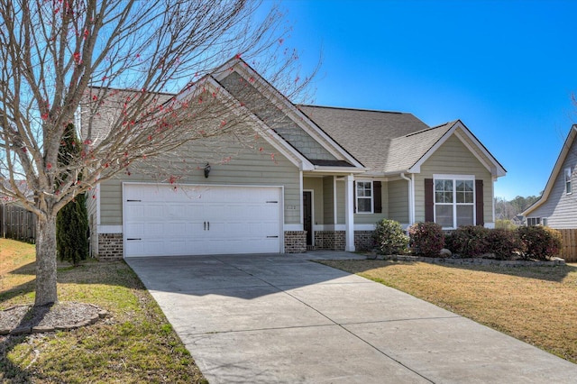 view of front of house featuring driveway, an attached garage, a front yard, and fence