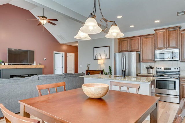 dining room with light wood finished floors, visible vents, vaulted ceiling with beams, ceiling fan, and recessed lighting