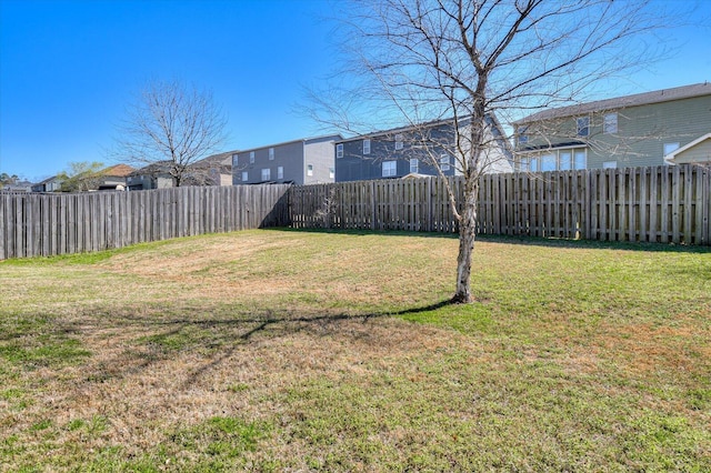 view of yard featuring a residential view and a fenced backyard