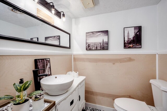 707 Oriole St, Aiken, SC 29803 - half bathroom featuring toilet, vanity, and a textured ceiling