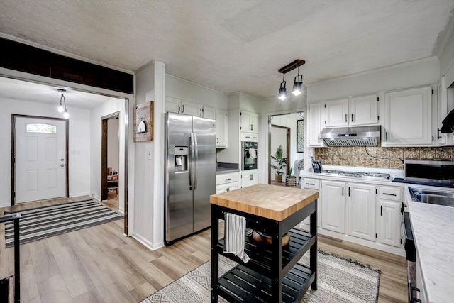 707 Oriole St, Aiken, SC 29803 - kitchen with stainless steel appliances, under cabinet range hood, white cabinetry, backsplash, and light wood-style floors