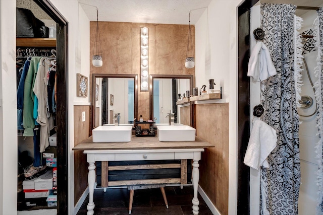 707 Oriole St, Aiken, SC 29803 - bathroom featuring double vanity, baseboards, and a spacious closet