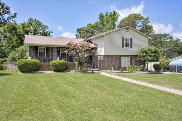 707 Oriole St, Aiken, SC 29803 - split level home featuring brick siding, a front yard, a porch, and metal roof