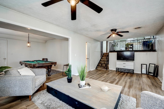 707 Oriole St, Aiken, SC 29803 - living room with ceiling fan, billiards table, wood finished floors, stairs, and a textured ceiling