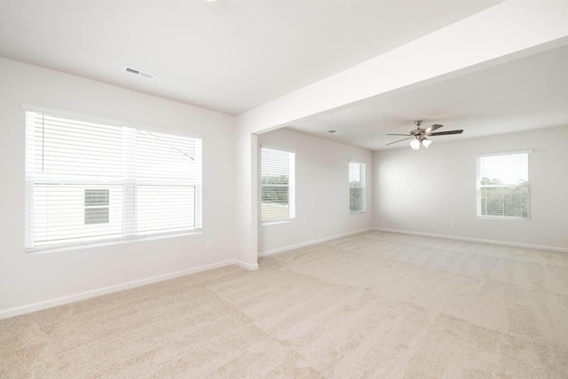 spare room with light colored carpet and ceiling fan