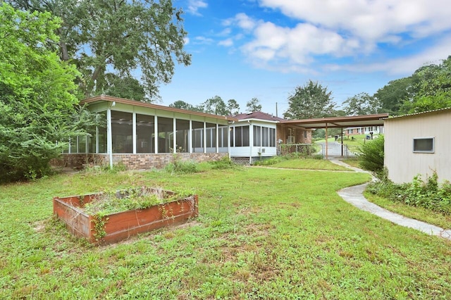 3613 Concord Ct, Augusta, GA 30906 - view of grassy yard featuring a sunroom, an attached carport, and a garden