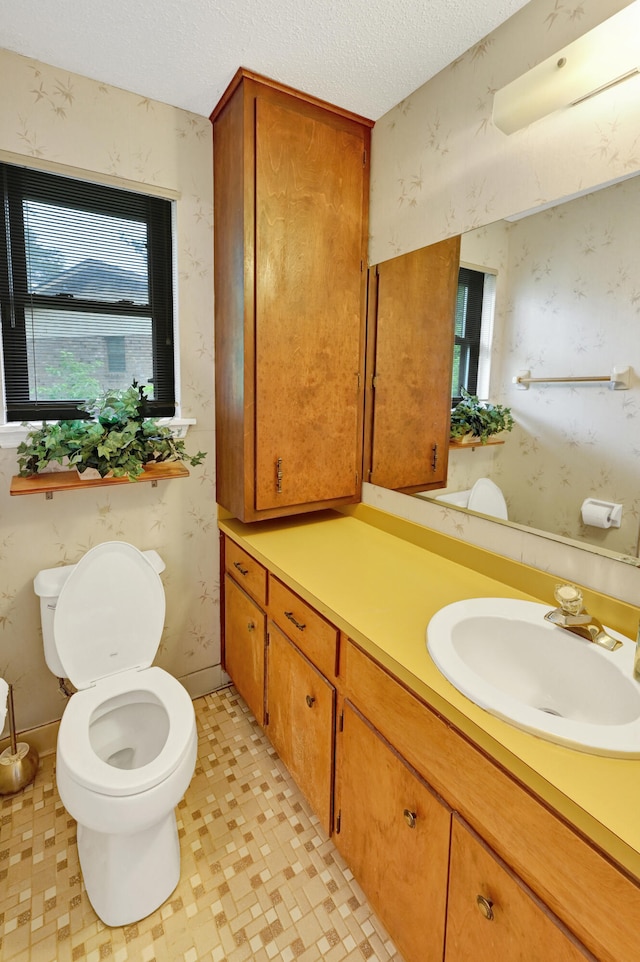 3613 Concord Ct, Augusta, GA 30906 - bathroom with vanity, wallpapered walls, healthy amount of natural light, and a textured ceiling