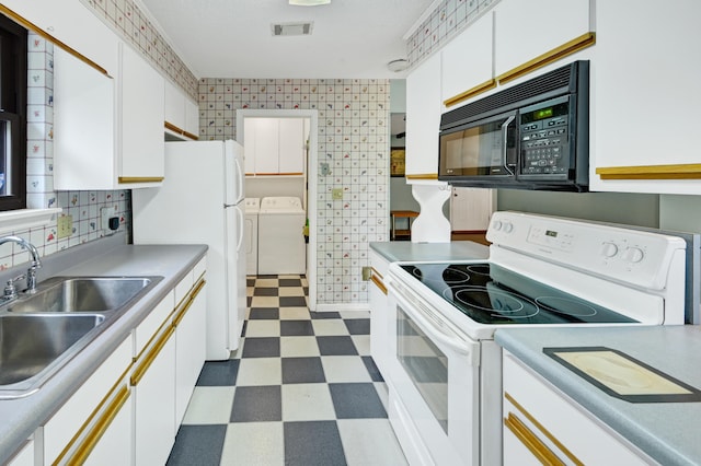 3613 Concord Ct, Augusta, GA 30906 - kitchen with white appliances, washing machine and dryer, dark flooring, white cabinets, and light countertops