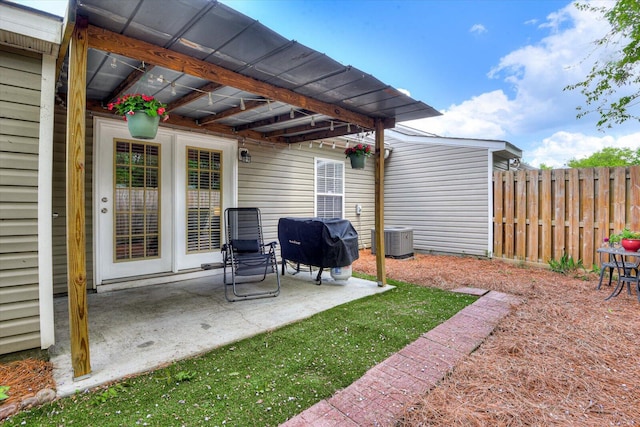 exterior space with grilling area, central AC, and fence