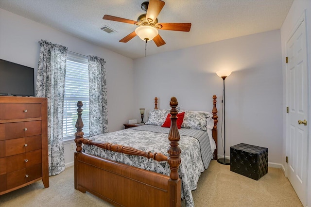 bedroom featuring visible vents, light colored carpet, and multiple windows