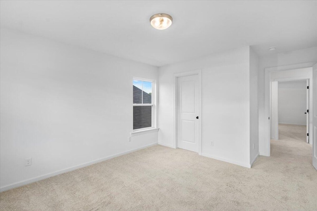 unfurnished bedroom featuring carpet floors and baseboards