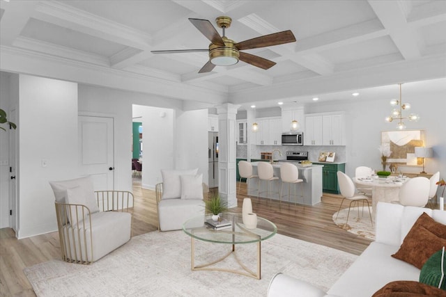 living area featuring light wood-style flooring, decorative columns, and beamed ceiling