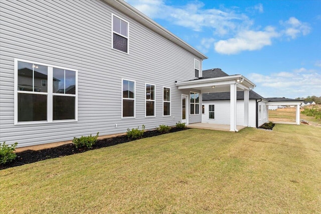 rear view of house with a yard and a patio area