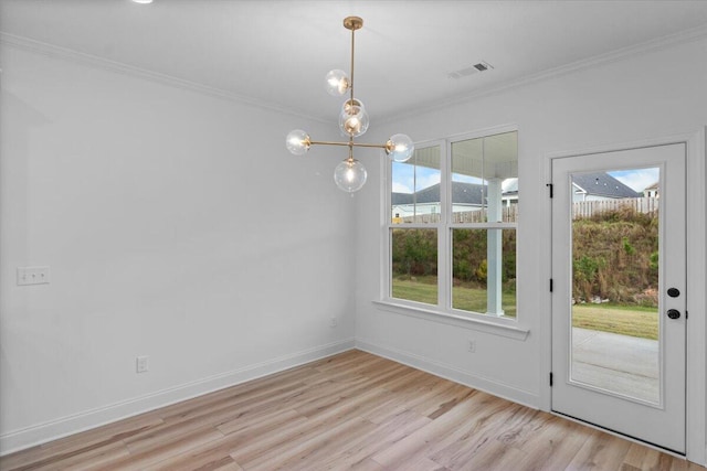 unfurnished dining area with visible vents, baseboards, light wood-style floors, ornamental molding, and an inviting chandelier