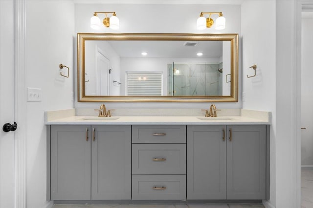 bathroom featuring a stall shower, visible vents, a sink, and double vanity