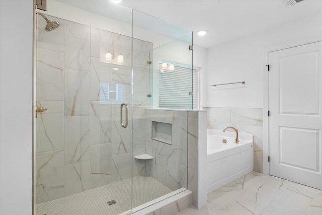 full bathroom featuring a garden tub, a wainscoted wall, tile walls, marble finish floor, and a marble finish shower