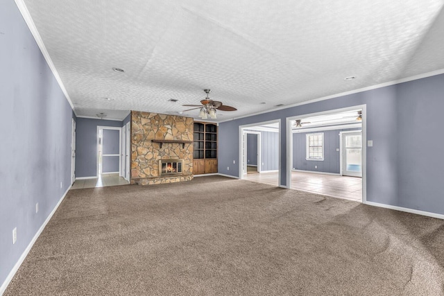 1736 Goshen Rd, Augusta, GA 30906 - unfurnished living room featuring carpet floors, a ceiling fan, crown molding, a stone fireplace, and a textured ceiling