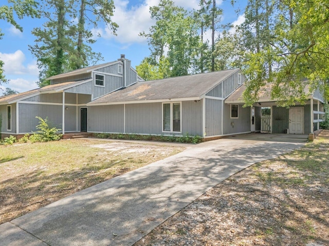 1736 Goshen Rd, Augusta, GA 30906 - mid-century home with concrete driveway, a carport, and a chimney