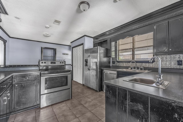 1736 Goshen Rd, Augusta, GA 30906 - kitchen featuring appliances with stainless steel finishes, dark countertops, ornamental molding, a textured ceiling, and dark tile patterned flooring