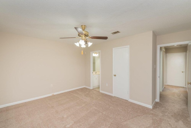 112 W Lynne Dr, Augusta, GA 30907 - unfurnished bedroom featuring light colored carpet, ensuite bathroom, a ceiling fan, and a textured ceiling