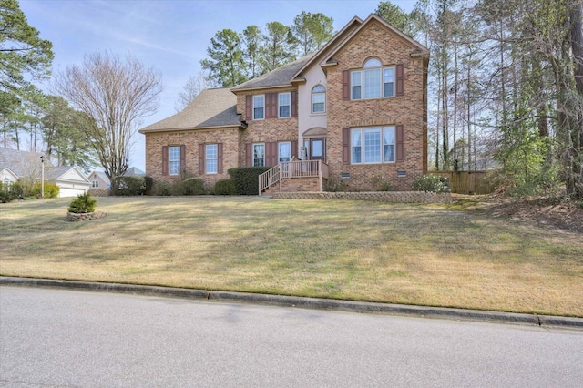 view of front facade featuring brick siding and a front lawn