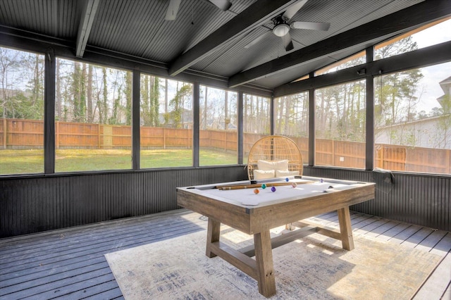 sunroom featuring lofted ceiling with beams and a ceiling fan