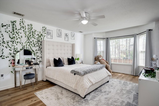 bedroom with visible vents, light wood-style flooring, and ceiling fan