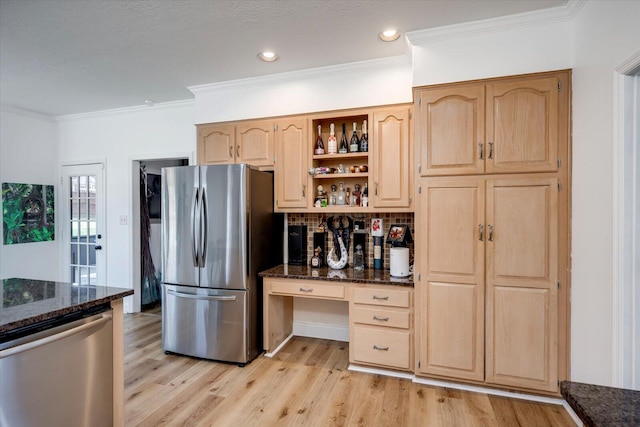 kitchen featuring light brown cabinetry, light wood-style flooring, stainless steel appliances, and dark stone counters