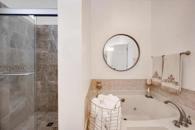 full bathroom featuring a shower stall and a whirlpool tub