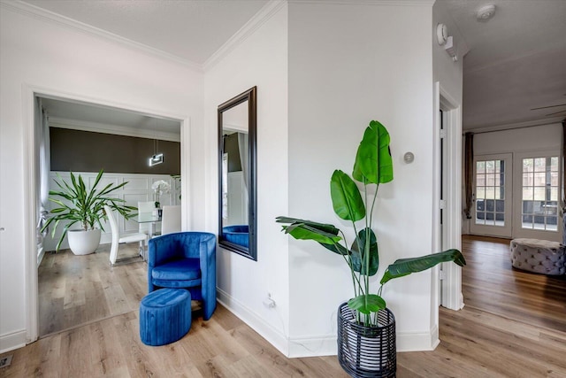 hallway featuring crown molding, wood finished floors, and baseboards