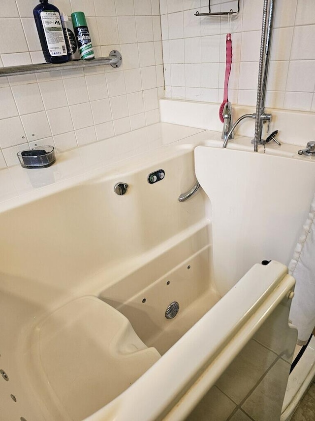 full bath featuring tasteful backsplash and a tub to relax in