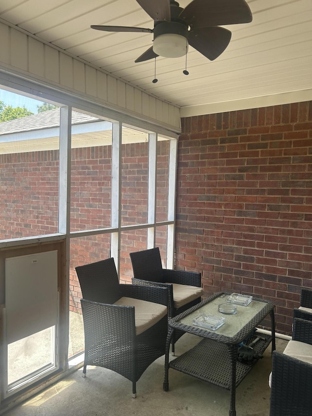 sunroom featuring ceiling fan