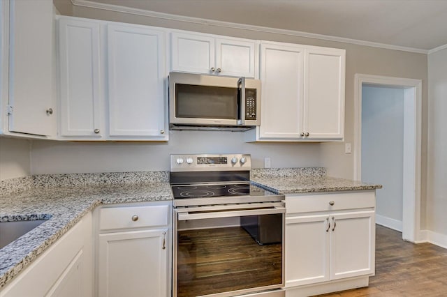 kitchen featuring appliances with stainless steel finishes, light stone counters, ornamental molding, hardwood / wood-style floors, and white cabinetry