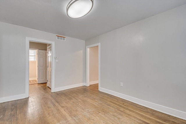 unfurnished room with light hardwood / wood-style flooring