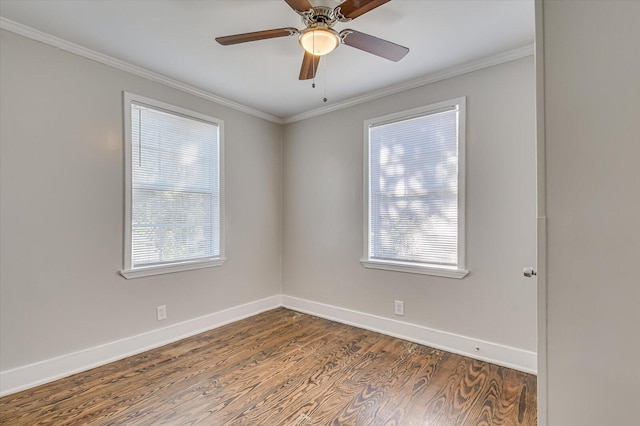 spare room with hardwood / wood-style flooring, a wealth of natural light, ornamental molding, and ceiling fan